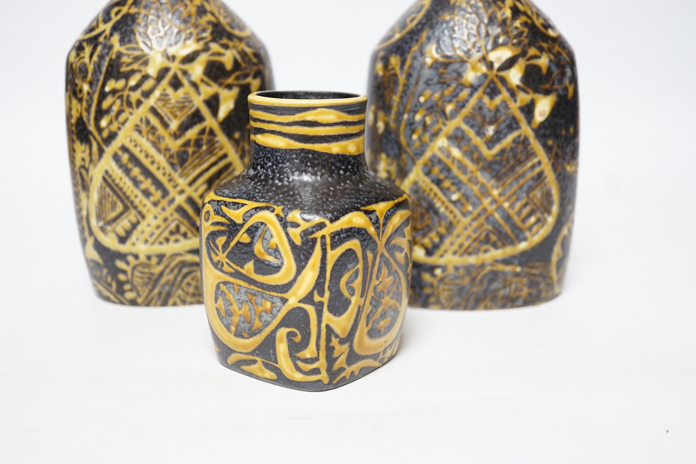 A pair of Royal Copenhagen brown and yellow decorated fajance vases marked 3208 on base and a similar bird decorated squat vase marked 3361 on base, pair of vases 18cm high